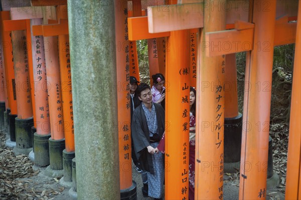 24.12.2017, Kyoto, Japan, Asia, A group of Japanese people walk up one of the torii pathways