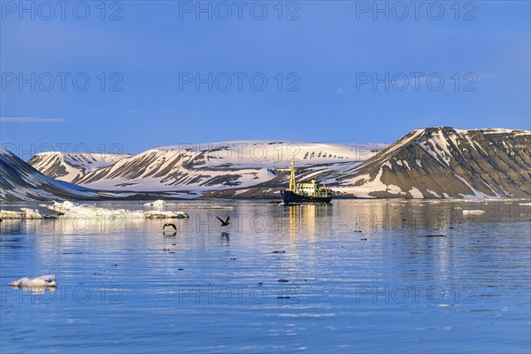 Ship in a bay at the coast in Spitsbergen