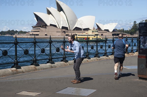 25.09.2019, Sydney, New South Wales, Australia, A man holds an ice cream in his hand and takes a