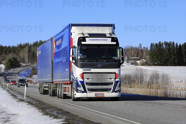 New Volvo FH truck Koskinen Yhtiot pulls freight trailer along highway 52 on a day of spring. Salo,