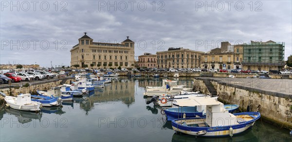 Syracuse, Italy, 28 December, 2023: colourful boats in the harbour between Syracuse and Ortygia