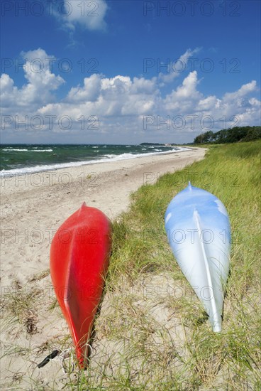 Red and blue Canoe on the beach near the Danish village Saltofte on the isle of Funen
