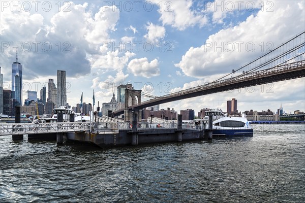 New York City, USA, June 24, 2018: Pier in East River Against Cityscape of Downtown of Manhattan