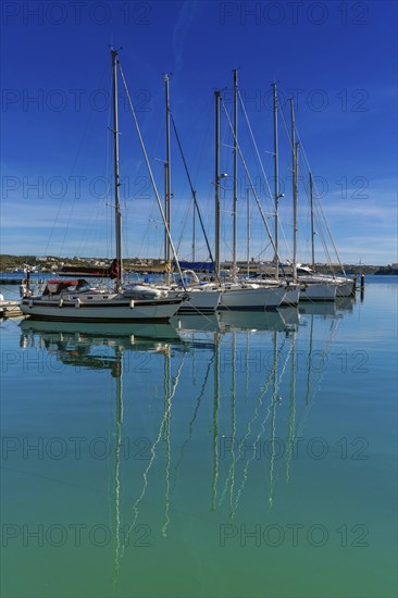 Mahon, Spain, 24 January, 2024: vertical view of moored sailboats in the harbour of Mahon on