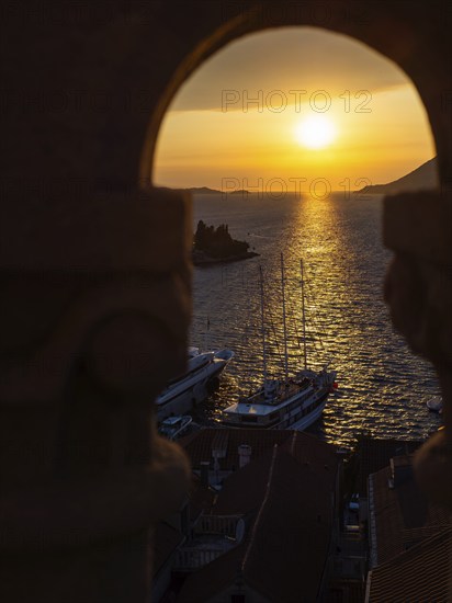 Evening atmosphere at sunset by the sea, view from the bell tower, ship in Korcula harbour, Korcula
