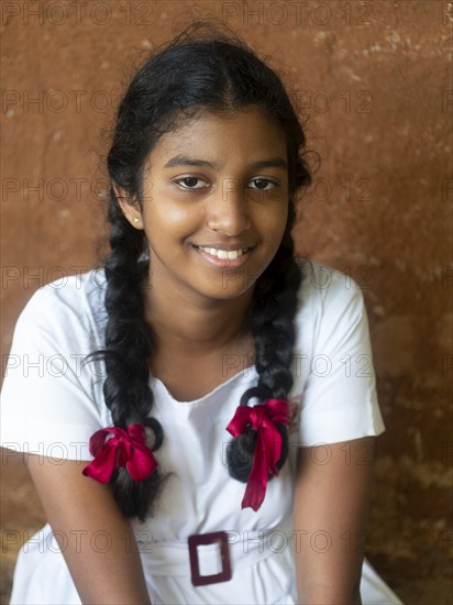 Sinhalese schoolgirl with white clothes, black braids and red ribbons, Sri Lanka, Asia