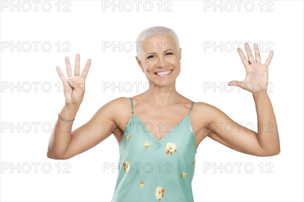 Happy senior woman showing number 45 with her fingers
