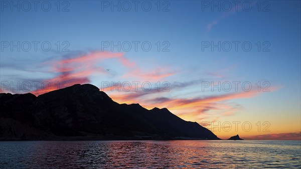 Blue evening sky, pink illuminated clouds, rocky coast, sunset, dusk, Marettimo, Egadi Islands,