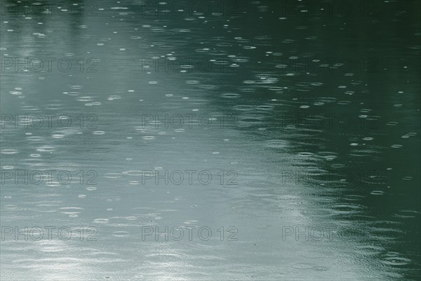 Raindrops on emerald green reservoir, Stillup reservoir, Stilluptal, Mayrhofen, High Mountain