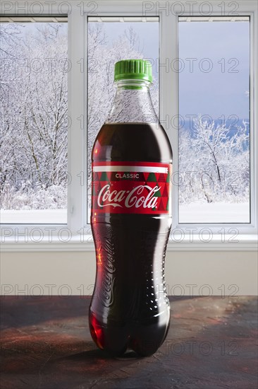 December 7, 2018, Minsk, Belarus, bottle of Coca-Cola on the table with winter view in the window
