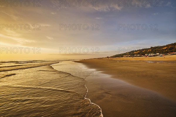 Atlantic ocean sunset with surging waves at Fonte da Telha beach, Costa da Caparica, Portugal,