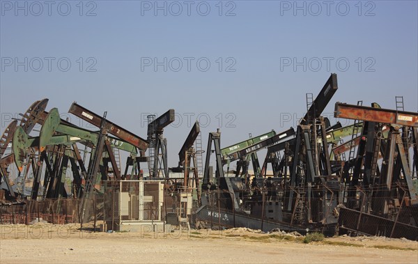 Storage with disused oil pumps near Marmul, Oman, Asia