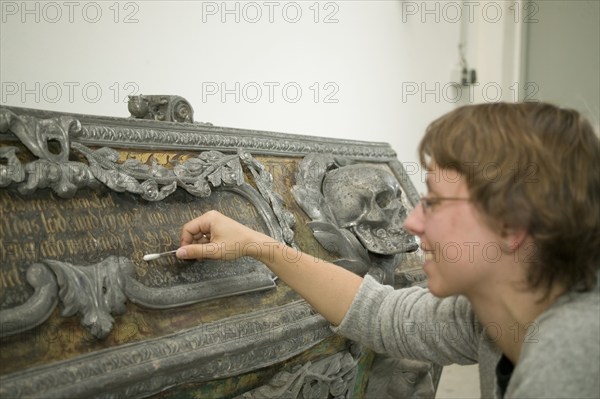 Restorer at Fuchs&Gierke, here a metal sarcophagus from a family vault is expertly cleaned and