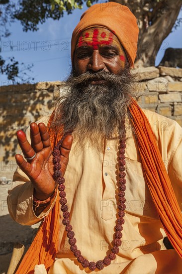 JAISALMER, INDIA, NOVEMBER 28, 2012: Indian sadhu (holy man) blessing. Sadhus are holy men who live