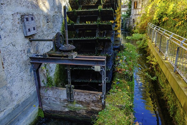 Symbolic image of historical mill wheel and concept of water energy and sustainability, here using