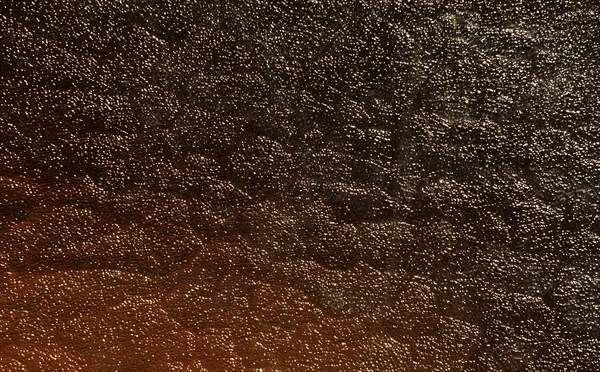 Light reflections on a pane of glass, abstract black and white orange background