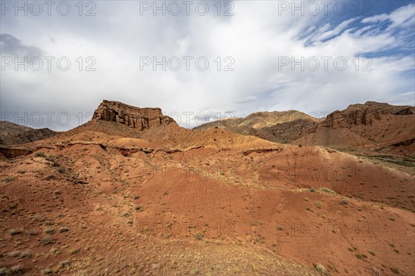 Eroded mountain landscape with sandstone cliffs, red and orange rock formations, Konorchek Canyon,