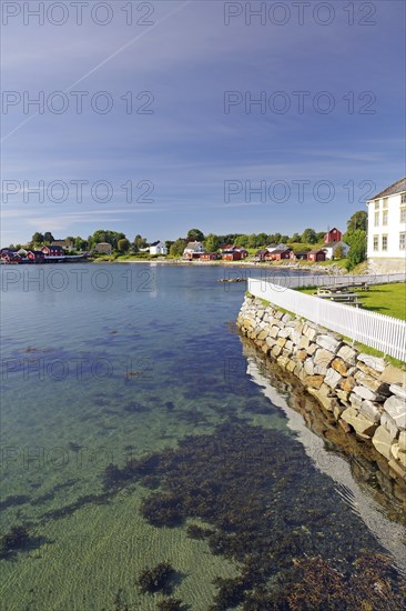 Bay with crystal clear water, some wooden buildings, Tjotta, FV 17, Kystriksveien, Helgeland,
