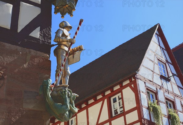 In the historic centre of Nuremberg, St. George as dragon slayer at Pilatus House (left) and houses
