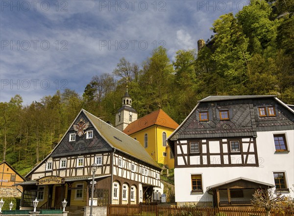 Half-timbered houses and small village church on a slope, Umgebindehäuser, Oybin, Zittau Mountains,