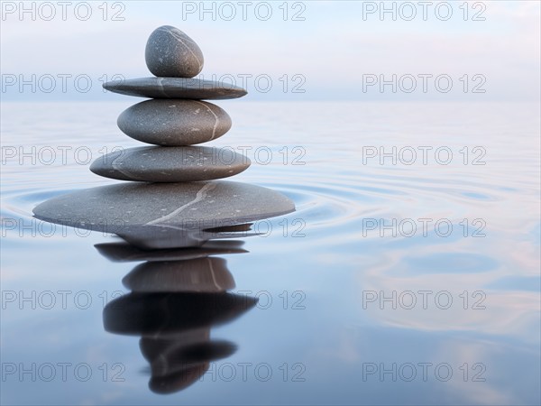 3d rendering of Zen stones in water with reflection, peace balance meditation relaxation concept