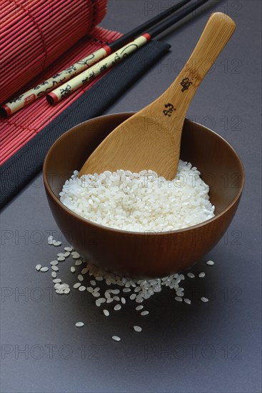 Rice, white rice in bowl with wooden ladle, uncooked
