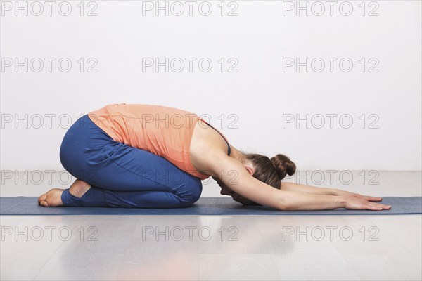 Woman relax in Hatha yoga asana Balasana, child's pose resting position or counter asana for many