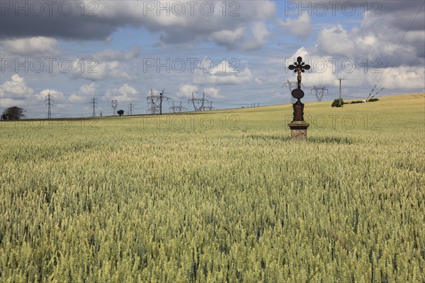 Field cross in a wheat field, in the background power lines, near Dukovany, Czech Republic, Grain