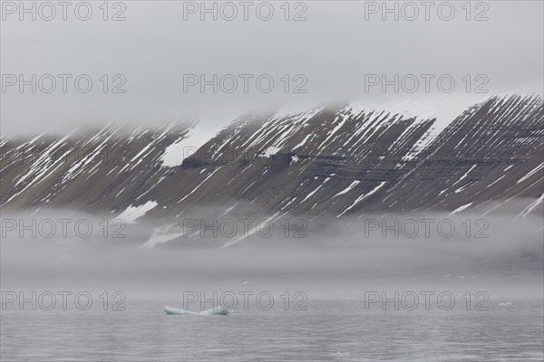 Mountains in the fog along the coast at Hinlopenstretet, Hinlopenstreet, Hinlopen strait between