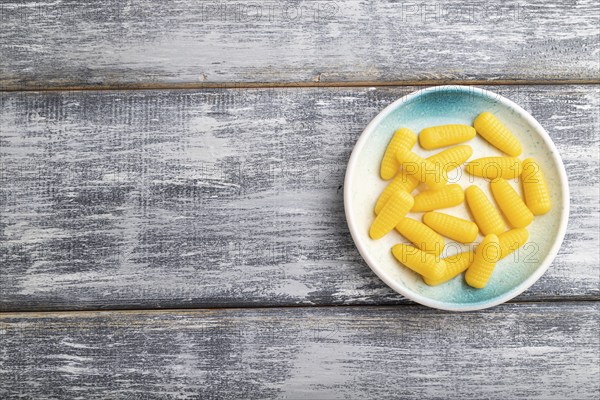 Jelly corn candies on gray wooden background. top view, flat lay, copy space