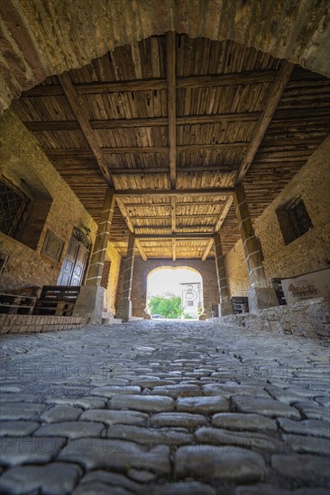 Interior view of a covered bridge with cobblestones and a wooden beam ceiling, Harz Mountains,