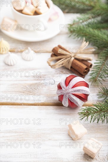 Christmas or New Year composition. Decorations, box, balls, cinnamon, fir and spruce branches, cup