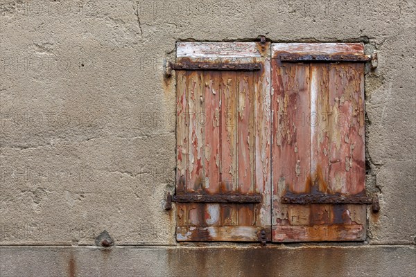 Window with dilapidated shutters and rusty iron fittings, Roscoff, Finistère, Brittany, France,