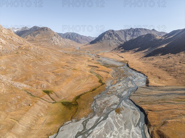 Aerial view, Burkhan mountain valley with meandering river, barren dramatic mountain landscape,