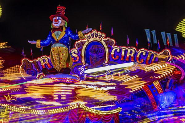 Illuminated round and elevated ride Circus Circus gondolas in motion, night shot, night shot