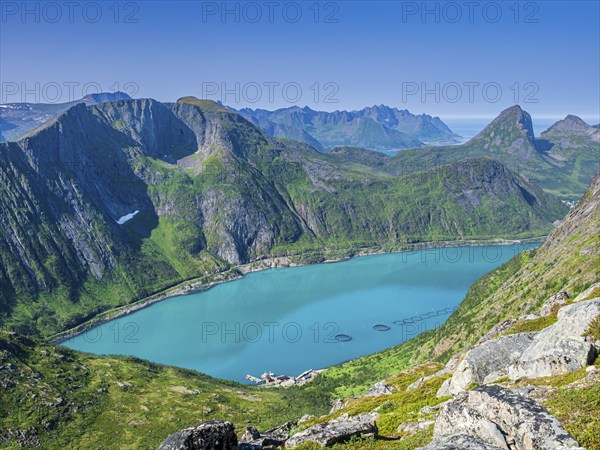 View over fjord Örnfjord to mountain Segla (right), road to Fjordgard, cages of salmon farm in the