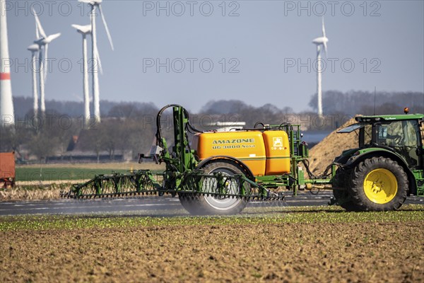Wind turbine, near Kerken, Kleve district, on the Lower Rhine, farmer applies pesticide, North