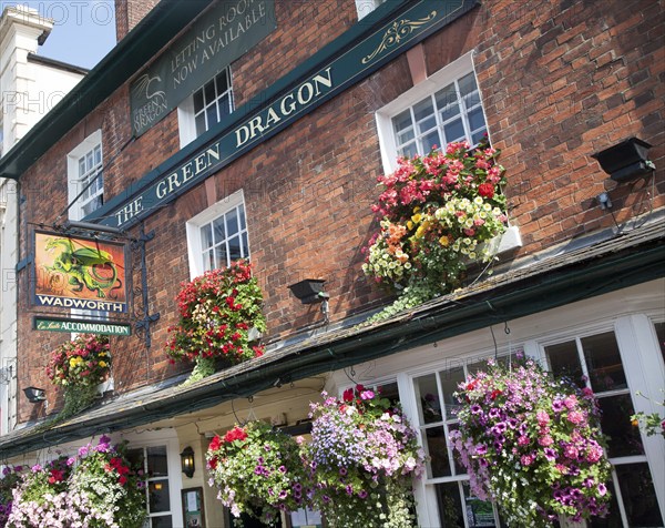 Exterior sign and floral display outside the Red Dragon pub in Marlborough, Wiltshire, England,