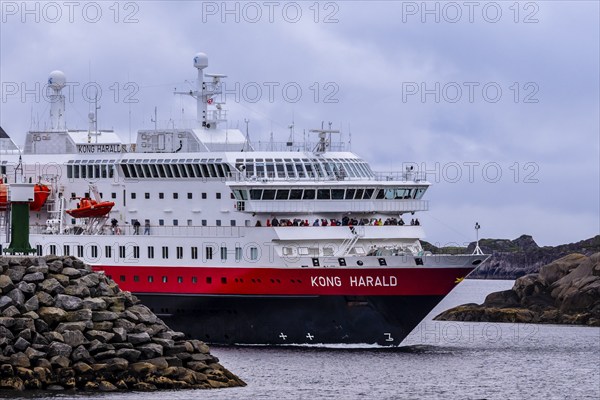 Ship 'Kong Harald' of Hurtigruten company is approaching harbor of Stamsund, island Vestvagøy,