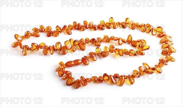Orange amber beads isolated on white background. top view, close up