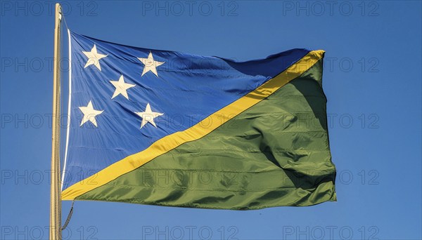 The flag of Solomon Islands, Solomon Islands, island nation in the South Seas, flutters in the