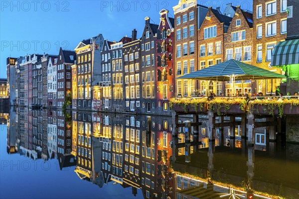 Canal houses on the Damrak, in the centre of the old town of Amsterdam, harbour, starting point of