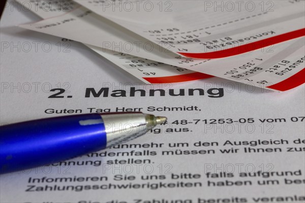 Symbolic image of debt, over-indebtedness: Close-up of bank statements and a reminder