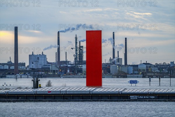Flood on the Rhine near Duisburg, freighters are moored in the harbour canal, industrial backdrop