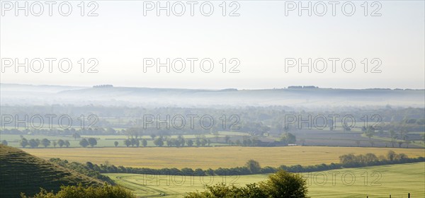 Early morning ground fog lying over fields in the Vale of Pewsey, near Alton Barnes, Wiltshire,