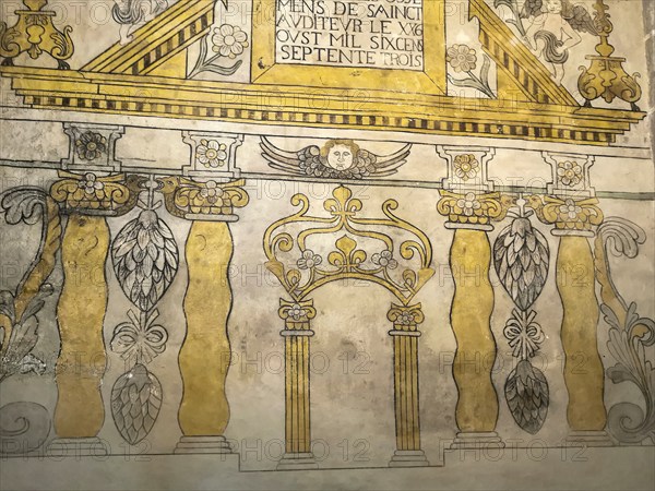 Saint-Nectaire. Ancient wall mural showcasing architectural elements in the church, Puy de Dome,