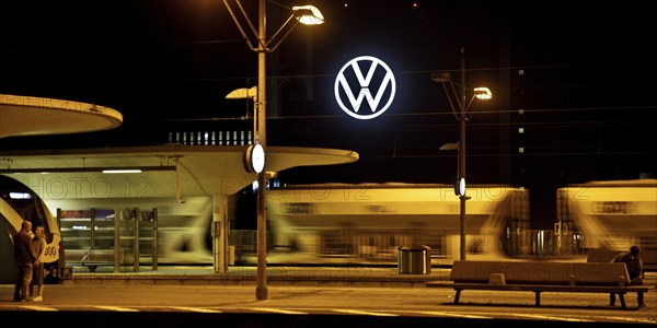 Wolfsburg main station at night with illuminated VW logo at the Volkswagen AG main plant, Lower
