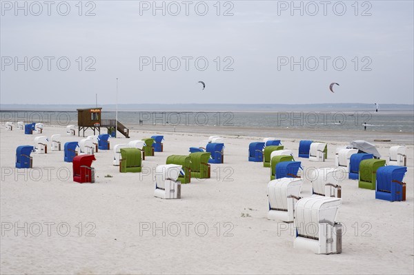 Beach chairs on the sandy beach, DLRG watchtower, kitesurfer on the North Sea, Utersum, Föhr, North