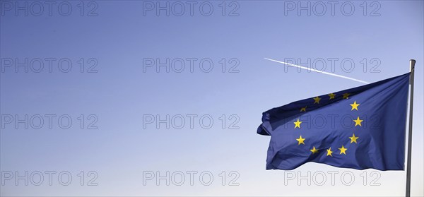 Flag of the European Union in front of a blue sky (Flag of the European Union in front of a blue