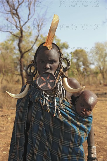 South Ethiopia, in Maco National Park, Mursi tribe, Mursi woman with baby, painted skin and